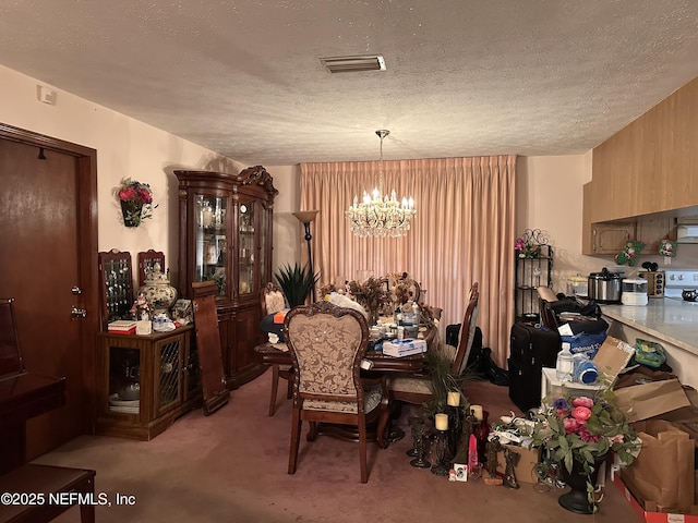 dining room with an inviting chandelier, light colored carpet, and a textured ceiling