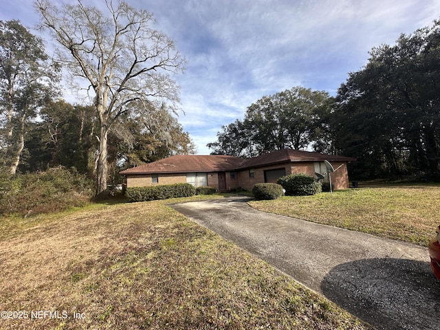 ranch-style house with a garage and a front yard