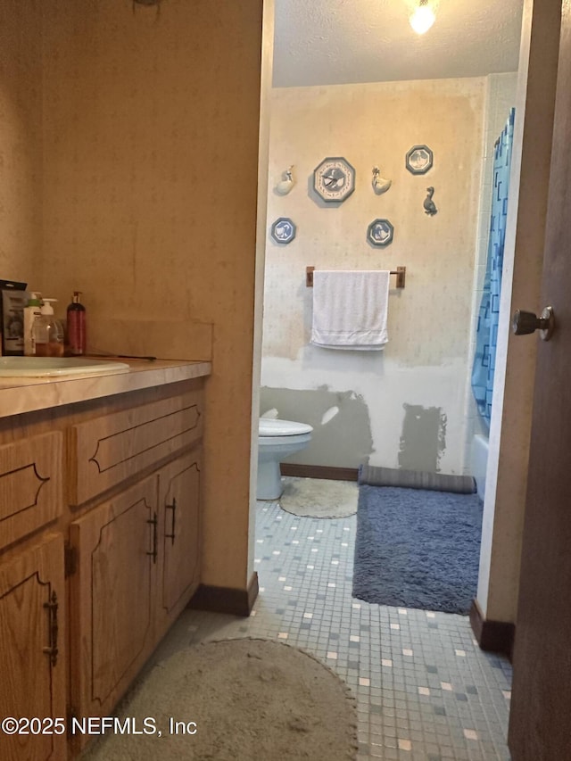 full bathroom with tile patterned floors, vanity, toilet, and shower / bath combo with shower curtain