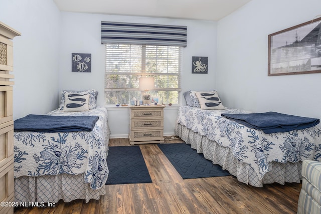 bedroom with dark hardwood / wood-style floors