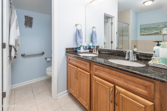 bathroom with vanity, toilet, an enclosed shower, and tile patterned flooring