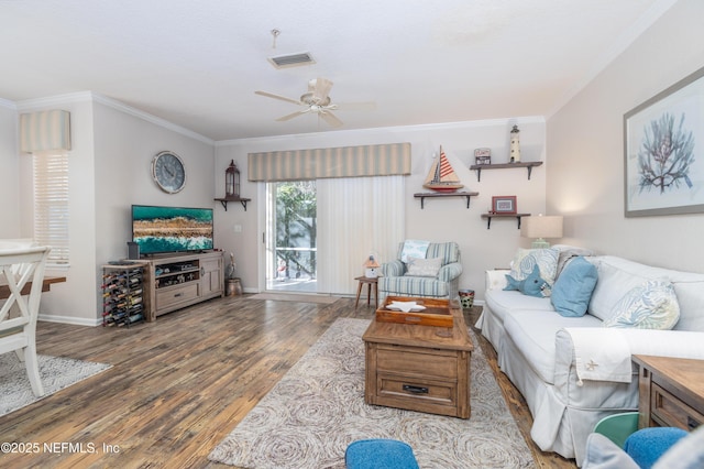 living room featuring crown molding, ceiling fan, and wood-type flooring