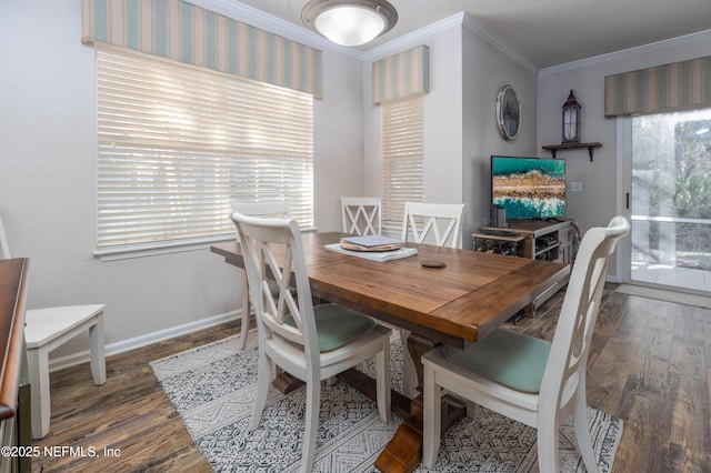 dining room featuring dark hardwood / wood-style flooring, crown molding, and plenty of natural light