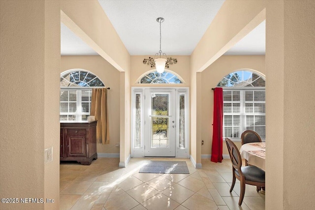 foyer with a healthy amount of sunlight and light tile patterned flooring