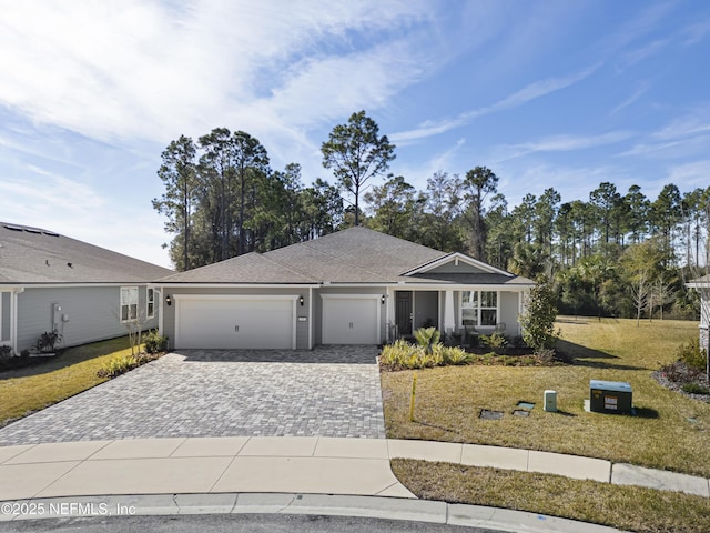 ranch-style house featuring a garage and a front lawn