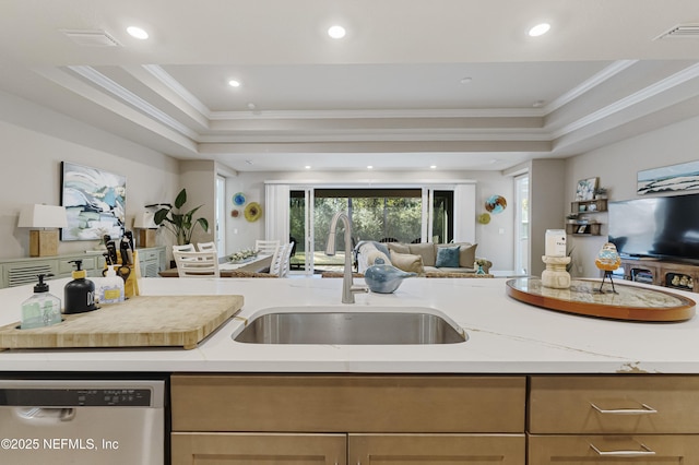 kitchen featuring crown molding, stainless steel dishwasher, a raised ceiling, and sink