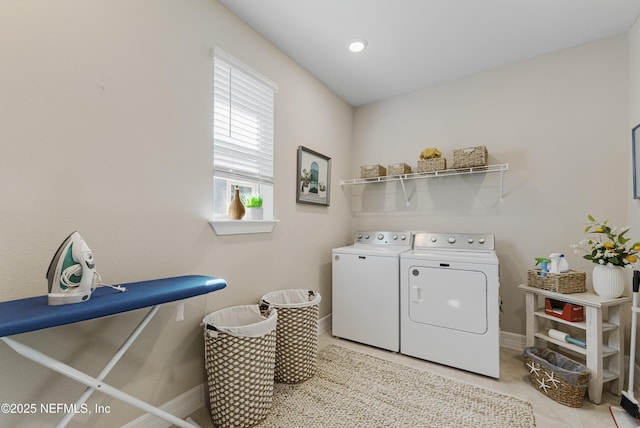 washroom with light tile patterned floors and washing machine and clothes dryer