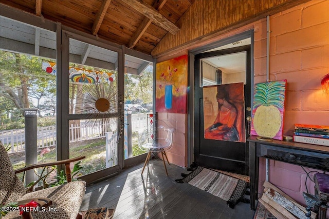 sunroom featuring lofted ceiling with beams and wooden ceiling