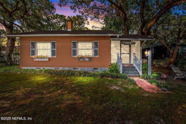 view of front of home with a lawn