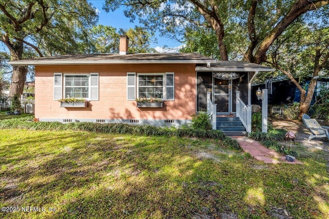 view of front of property with central AC and a front yard