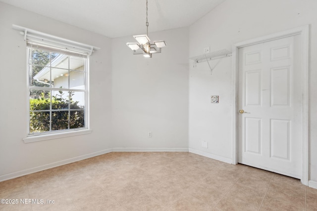 empty room with a notable chandelier