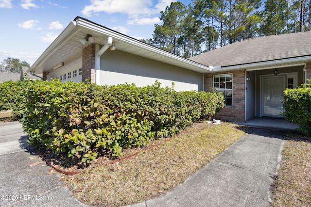 view of side of home featuring a garage