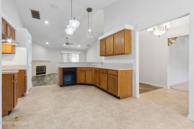 kitchen featuring lofted ceiling, dishwasher, kitchen peninsula, pendant lighting, and ceiling fan with notable chandelier