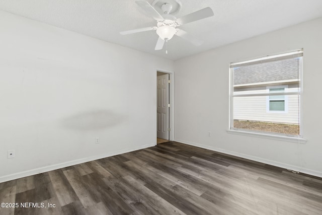 spare room featuring dark hardwood / wood-style floors, a textured ceiling, and ceiling fan