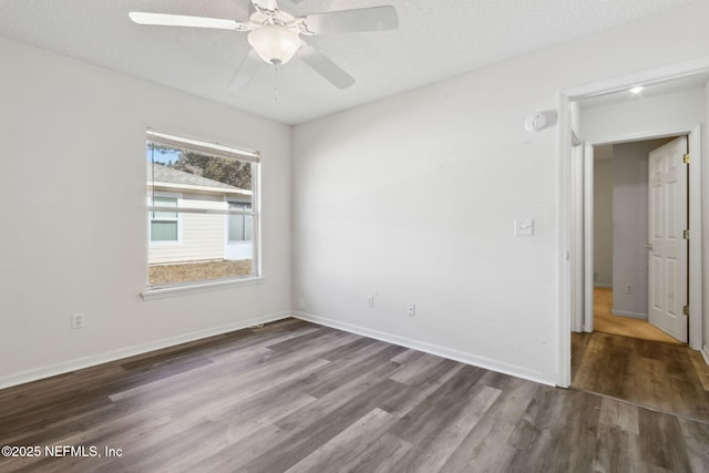 spare room with ceiling fan, wood-type flooring, and a textured ceiling