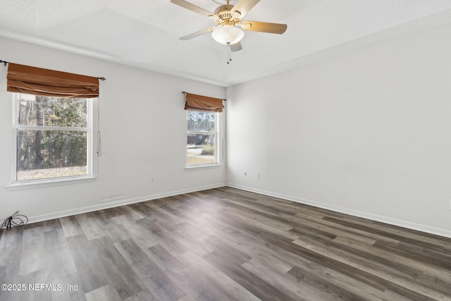 unfurnished room featuring ceiling fan, dark hardwood / wood-style floors, and a textured ceiling