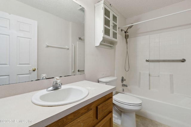 full bathroom featuring toilet,  shower combination, a textured ceiling, vanity, and tile patterned flooring