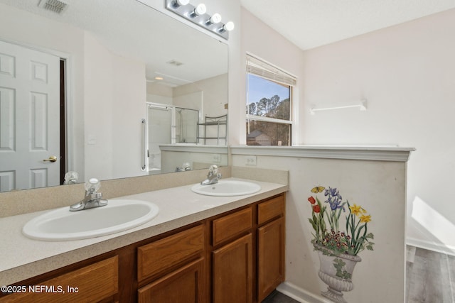 bathroom featuring vanity and an enclosed shower