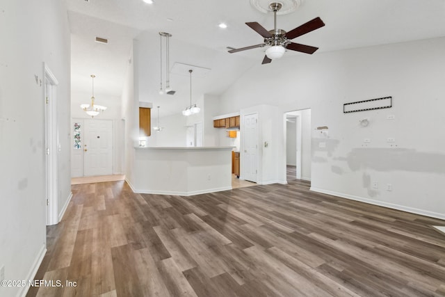 unfurnished living room with wood-type flooring, high vaulted ceiling, and ceiling fan