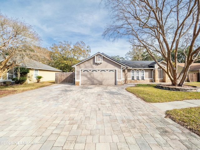 ranch-style home with a garage and a front lawn