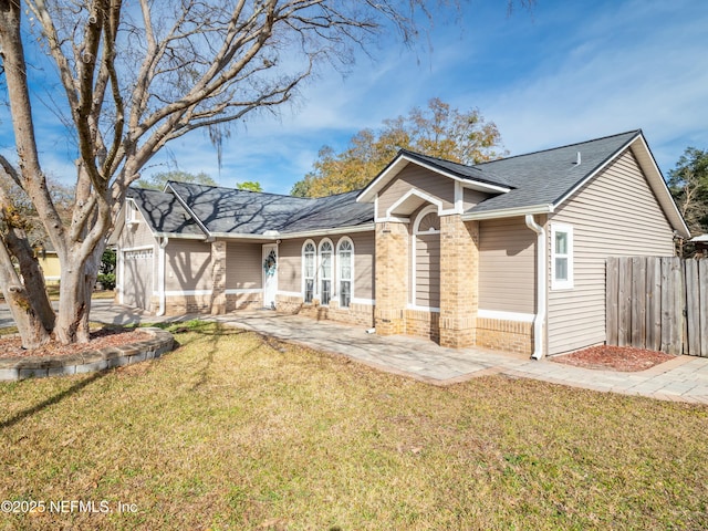 view of front of home with a garage and a front yard