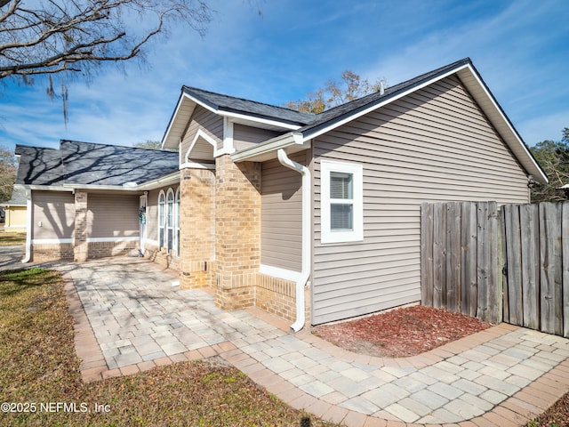 view of side of home featuring a patio area