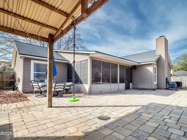 back of property featuring a gazebo, a patio, and a sunroom