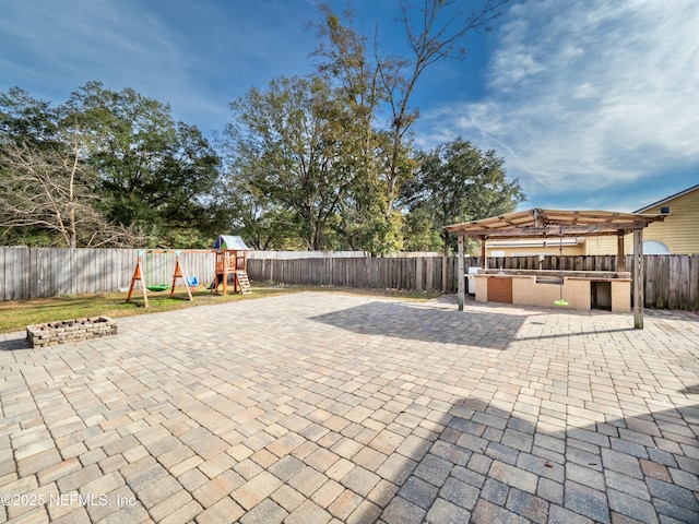 view of patio / terrace with area for grilling and a playground