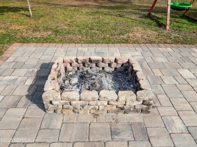 exterior details featuring an outdoor fire pit