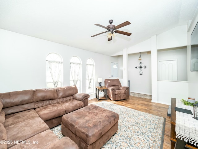 living room featuring ceiling fan, lofted ceiling, and light hardwood / wood-style floors