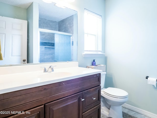 bathroom with vanity, a textured ceiling, toilet, and walk in shower