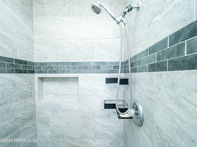 interior details featuring tiled shower