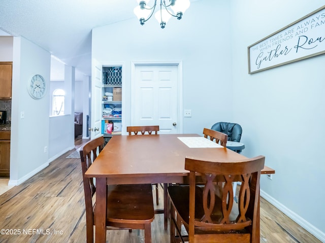 dining area featuring hardwood / wood-style flooring and a chandelier