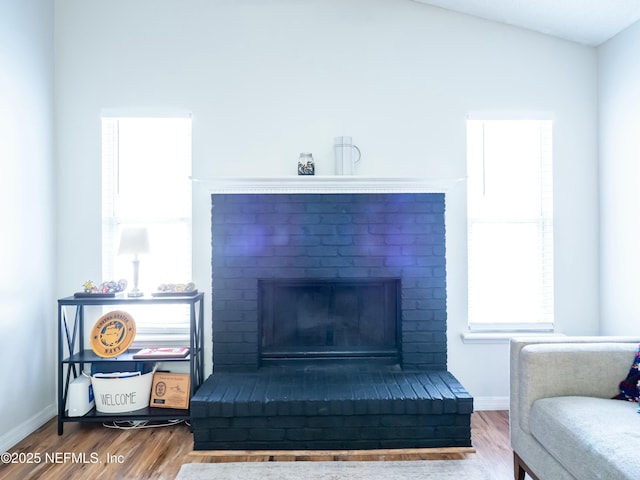 sitting room featuring hardwood / wood-style flooring and a fireplace