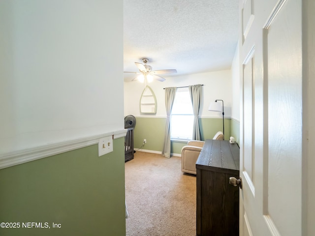 carpeted bedroom with ceiling fan and a textured ceiling