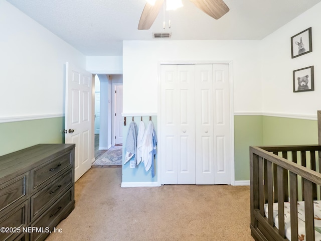 carpeted bedroom featuring a closet and ceiling fan