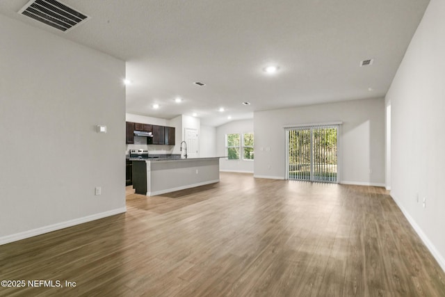 unfurnished living room with sink and light hardwood / wood-style flooring