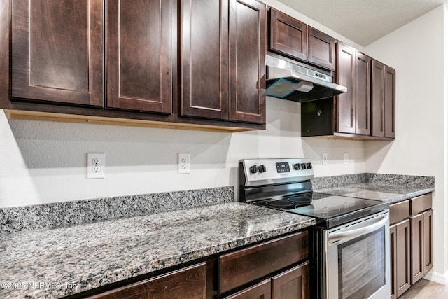 kitchen featuring stainless steel range with electric stovetop, dark brown cabinets, and light stone countertops