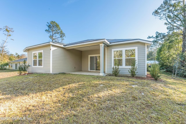 back of house featuring a yard and a patio