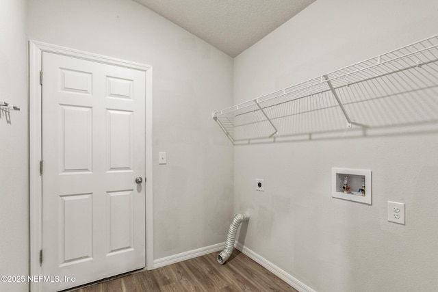 laundry room featuring washer hookup, hardwood / wood-style floors, and electric dryer hookup