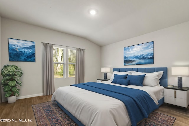 bedroom with lofted ceiling and hardwood / wood-style flooring