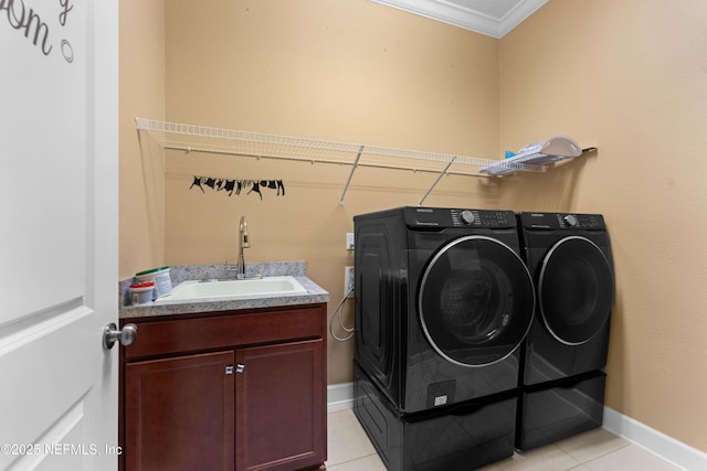 laundry room with sink, crown molding, light tile patterned floors, cabinets, and independent washer and dryer