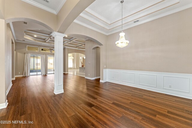 spare room featuring coffered ceiling, ornamental molding, dark hardwood / wood-style flooring, and decorative columns