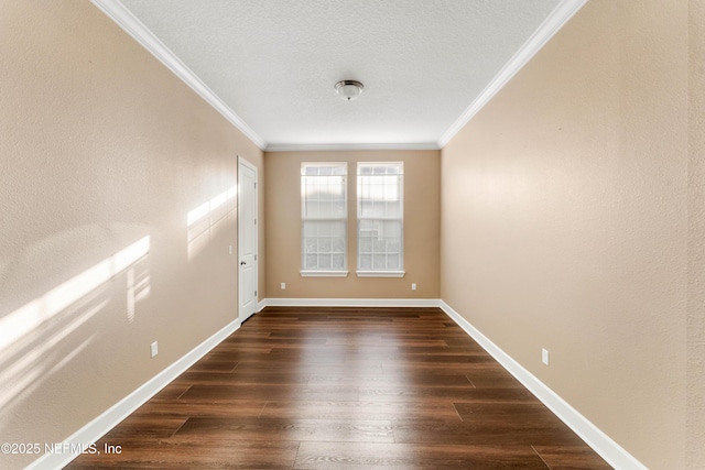 spare room featuring crown molding, dark wood-type flooring, and a textured ceiling