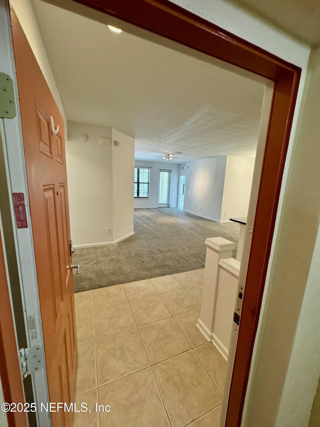 corridor with light colored carpet