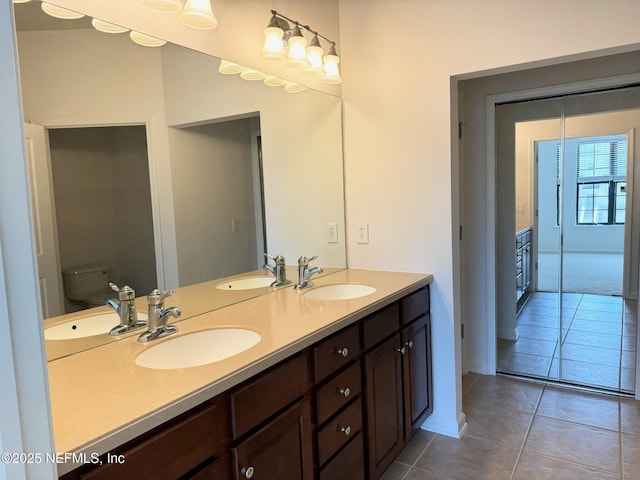 bathroom with tile patterned floors, vanity, and toilet