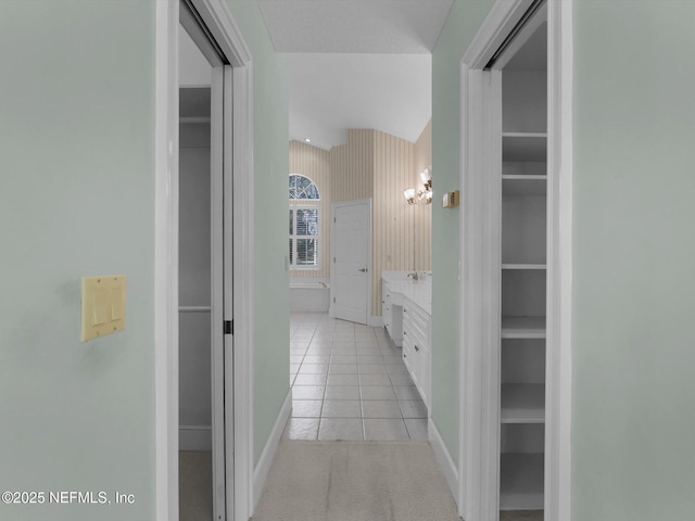 hall featuring light tile patterned floors