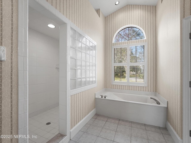 bathroom featuring tile patterned flooring, a wealth of natural light, shower with separate bathtub, and vaulted ceiling