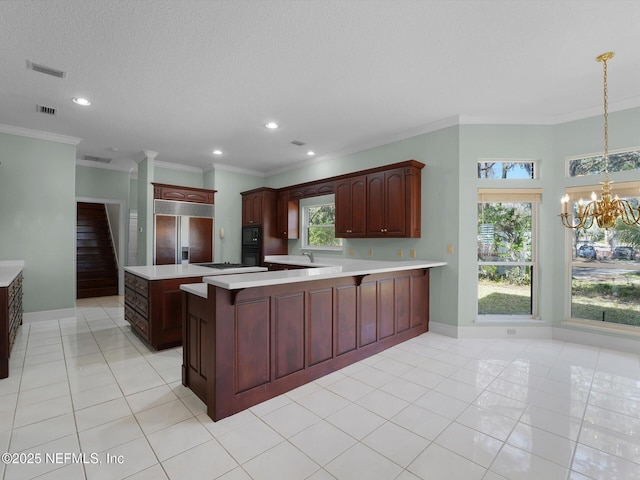 kitchen with black appliances, a kitchen island, decorative light fixtures, light tile patterned flooring, and a chandelier