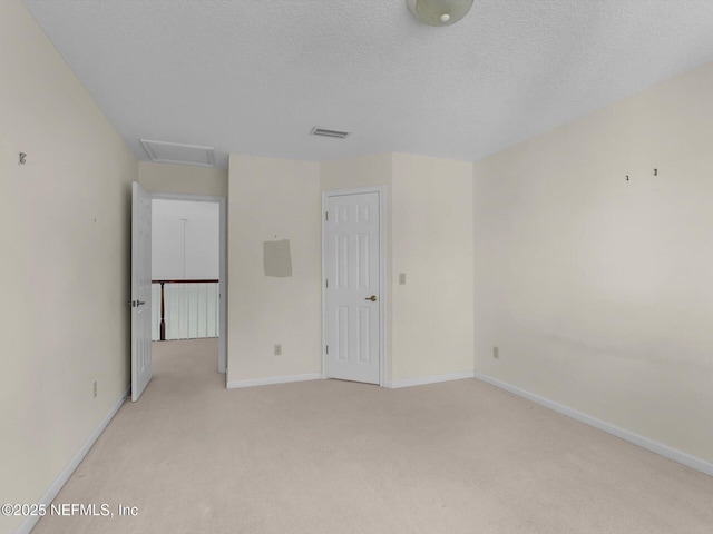 carpeted spare room featuring a textured ceiling